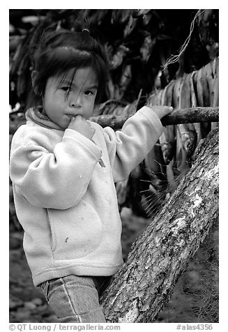 Inupiaq Eskimo girl near drying fish, Ambler. North Western Alaska, USA (black and white)