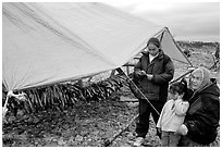 Inupiaq Eskimo family with stand of drying fish, Ambler. North Western Alaska, USA (black and white)