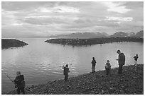 Fishing for salmon in the Spit's Fishing Hole. Homer, Alaska, USA ( black and white)