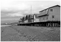 Beach and stilt houses on the Spit. Homer, Alaska, USA (black and white)