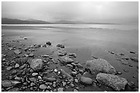 Sandy beach, rocks, and stormy skies on the Bay. Homer, Alaska, USA (black and white)