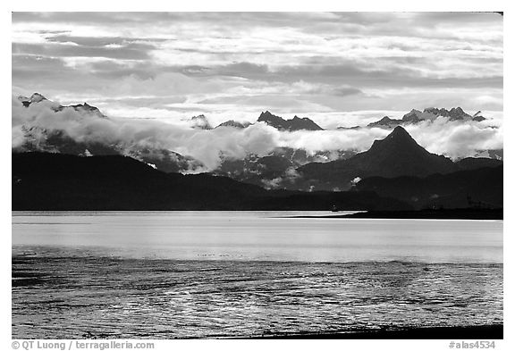 Low clouds haning over Kenai Mountains across Katchemak Bay. Homer, Alaska, USA