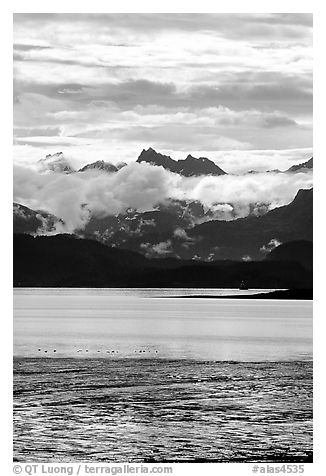 Low clouds hanging over Kenai Mountains across Katchemak Bay. Homer, Alaska, USA (black and white)