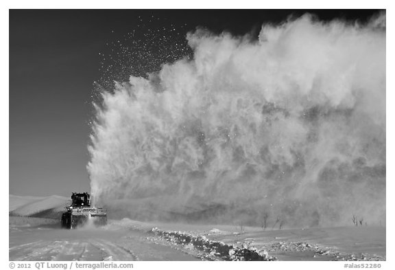 Snow plow truck with cloud of snow. Alaska, USA (black and white)