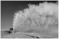 Snow plow truck with cloud of snow. Alaska, USA ( black and white)