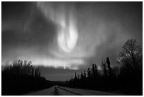 Aurora curtains above road. Alaska, USA ( black and white)