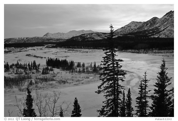 Winter landscape with frozen river at sunset. Alaska, USA (black and white)