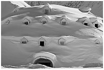 Snow-covered igloo-shaped building. Alaska, USA ( black and white)