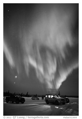 Northern Lights dance above snowy parking lot. Alaska, USA (black and white)