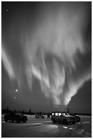 Northern Lights dance above snowy parking lot. Alaska, USA ( black and white)