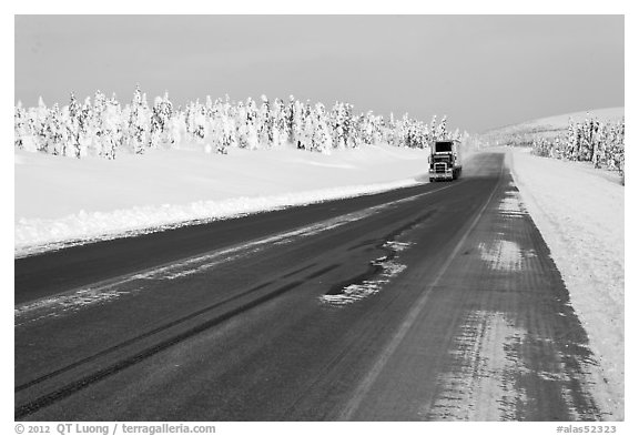 Dalton Highway bordered by snow-covered trees. Alaska, USA