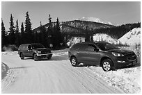 Car being pulled out of snowbank. Wiseman, Alaska, USA (black and white)