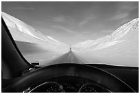 Road in wintry landscape seen from dashboard indicating -32F temperature. Alaska, USA ( black and white)