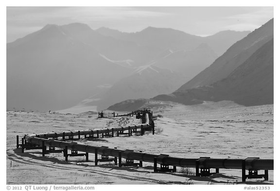 Alaska Pipeline snaking below Arctic Brooks mountains in winter. Alaska, USA