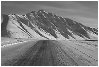 Frozen James Dalton Highway below Arctic Mountains. Alaska, USA (black and white)