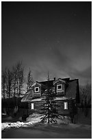 Cabin at night with Northern Lights. Wiseman, Alaska, USA (black and white)