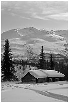 Snowy cabin and mountains. Wiseman, Alaska, USA (black and white)