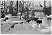 Trucks covered with piles of snow. Wiseman, Alaska, USA ( black and white)