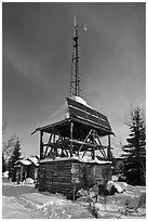 Tower with solar panels and windmill. Wiseman, Alaska, USA (black and white)