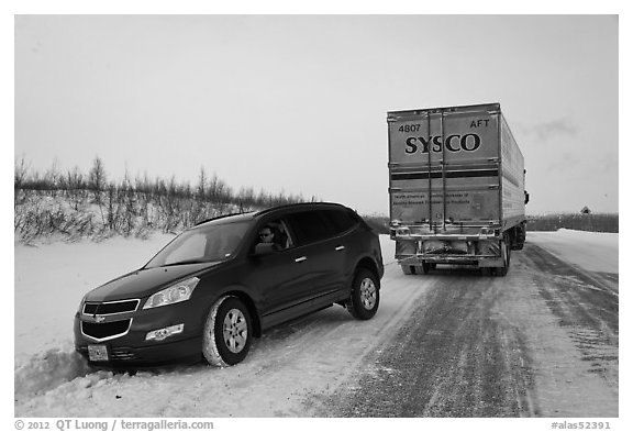 Commercial truck towing car, Dalton Highway. Alaska, USA