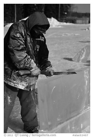 Ice artist carving with saw. Fairbanks, Alaska, USA (black and white)