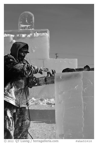 Sculptor using electric saw to carve ice. Fairbanks, Alaska, USA (black and white)