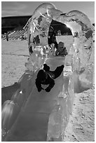 Children slide through ice sculpture. Fairbanks, Alaska, USA (black and white)
