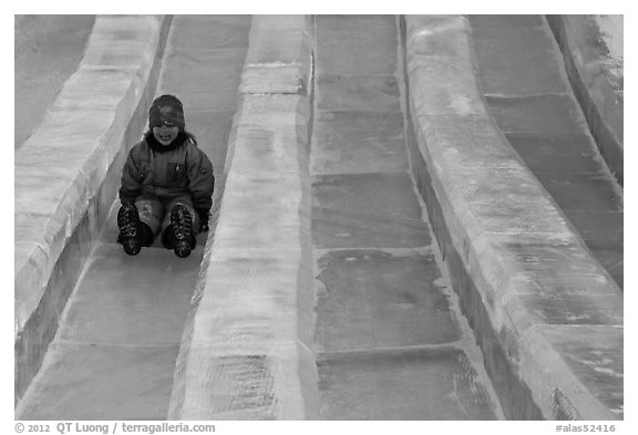 Girl on slide made of ice, George Horner Ice Park. Fairbanks, Alaska, USA (black and white)
