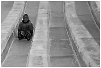 Girl on slide made of ice, George Horner Ice Park. Fairbanks, Alaska, USA ( black and white)