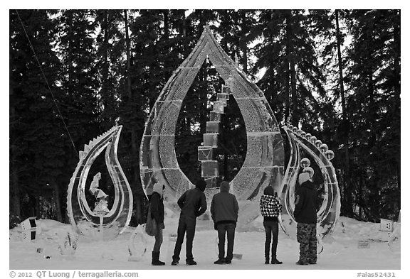 Tourists looking at ice sculpture, 2012 World Ice Art Championships. Fairbanks, Alaska, USA (black and white)