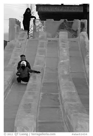 Lights come up inside ice slide at dusk. Fairbanks, Alaska, USA