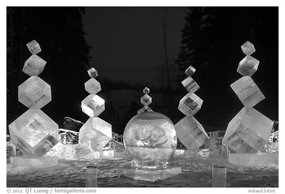 Balancing cubes made of ice at night, World Ice Art Championships. Fairbanks, Alaska, USA (black and white)