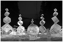 Balancing cubes made of ice at night, World Ice Art Championships. Fairbanks, Alaska, USA ( black and white)