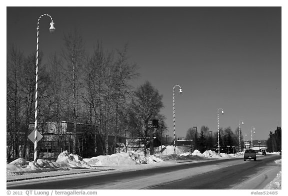 Main street and white street lights with red stripes. North Pole, Alaska, USA (black and white)