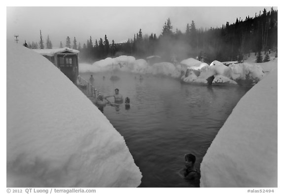 Soaking in natural hot pool surrounded by snow. Chena Hot Springs, Alaska, USA (black and white)