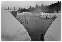 Soaking in natural hot pool surrounded by snow. Chena Hot Springs, Alaska, USA ( black and white)