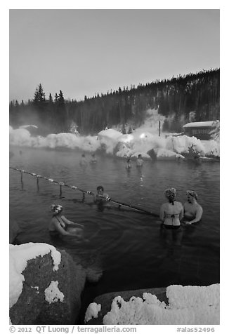 People soak in natural hot springs in winter. Chena Hot Springs, Alaska, USA (black and white)