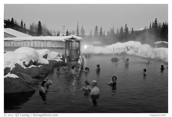 People soaking in outdoor hot springs pool in winter. Chena Hot Springs, Alaska, USA