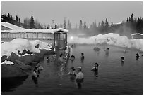 People soaking in outdoor hot springs pool in winter. Chena Hot Springs, Alaska, USA ( black and white)