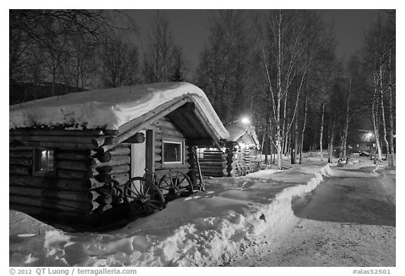 Path in snow and cabins at night. Chena Hot Springs, Alaska, USA (black and white)