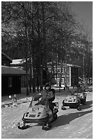 Snomobiler next to resort buildings. Chena Hot Springs, Alaska, USA (black and white)