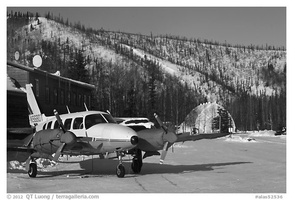 Plane with engine block warmers on frozen runway. Chena Hot Springs, Alaska, USA (black and white)