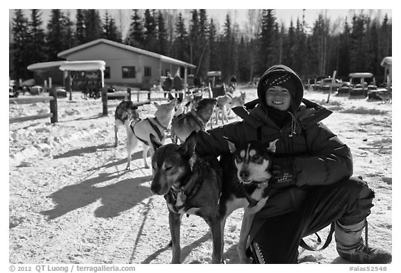 Woman dog musher posing with dog team. Chena Hot Springs, Alaska, USA