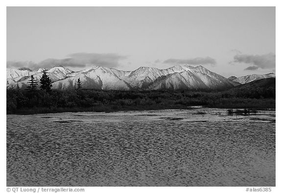 Lake with water ripples and mountains at sunset. Alaska, USA (black and white)