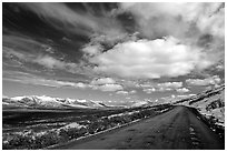 Denali Highway under large white clouds. Alaska, USA (black and white)