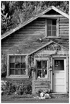 Dog in front of house in Copper Center. Alaska, USA (black and white)