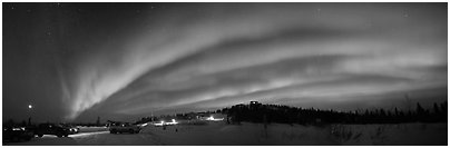 Northern Lights streaking above cars and cabin at Cleary Summit. Alaska, USA (Panoramic black and white)