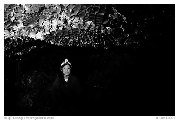 Caver inside a lava tube, Lava Beds National Monument. Lava Beds National Monument, California, USA (black and white)