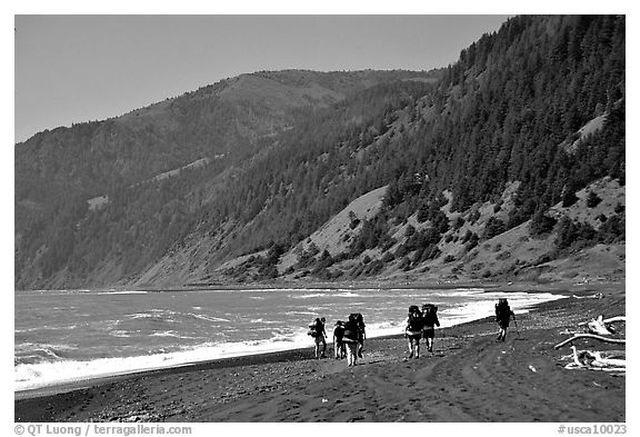 Backpackers on black sand beach and King Range, Lost Coast. California, USA