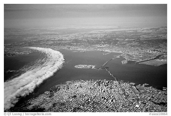 Aerial view of narrow band of fog rolling in from the Golden Gate besides the city. San Francisco, California, USA (black and white)